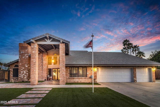 7763 W Libby St, Glendale, AZ 85308 - traditional home featuring fence, concrete driveway, a garage, brick siding, and a lawn