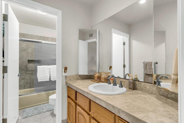 7763 W Libby St, Glendale, AZ 85308 - bathroom with tile patterned floors, bath / shower combo with glass door, toilet, visible vents, and vanity