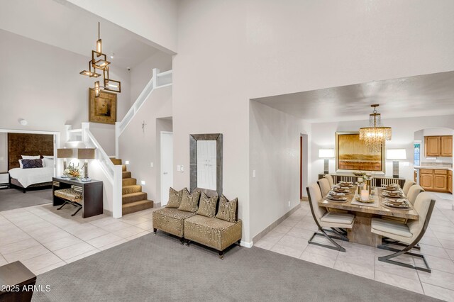 7763 W Libby St, Glendale, AZ 85308 - living area featuring stairway, a towering ceiling, a notable chandelier, and light tile patterned floors