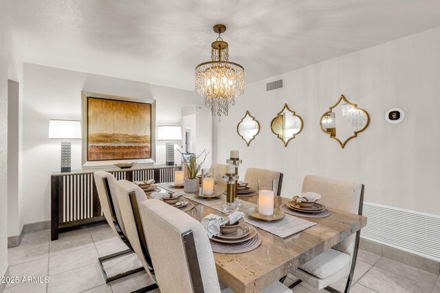 7763 W Libby St, Glendale, AZ 85308 - dining space featuring visible vents, arched walkways, a notable chandelier, and light tile patterned floors