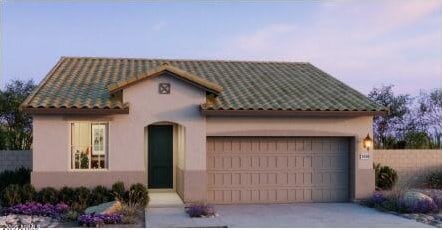 mediterranean / spanish-style home featuring concrete driveway, a tile roof, an attached garage, and stucco siding