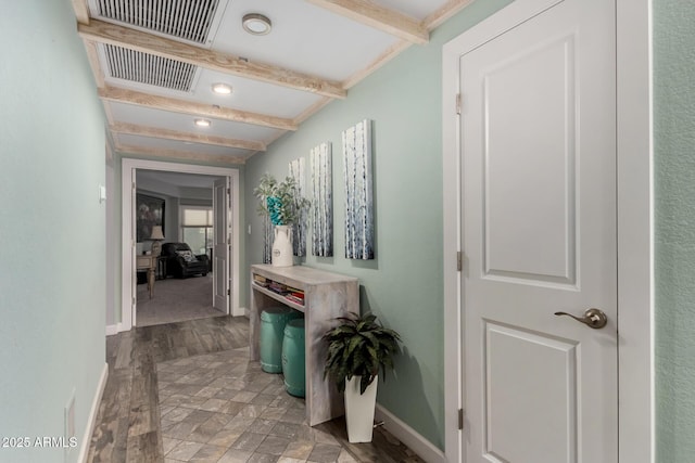 corridor featuring beamed ceiling and light hardwood / wood-style floors