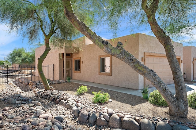 adobe home featuring a garage