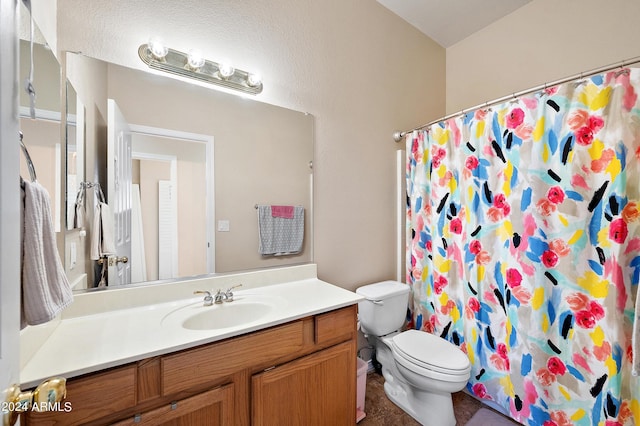 bathroom with vanity, toilet, and a shower with shower curtain