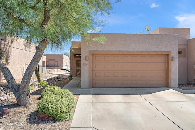 southwest-style home featuring a garage