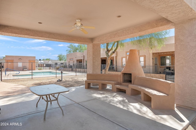 view of patio / terrace with ceiling fan and a community pool