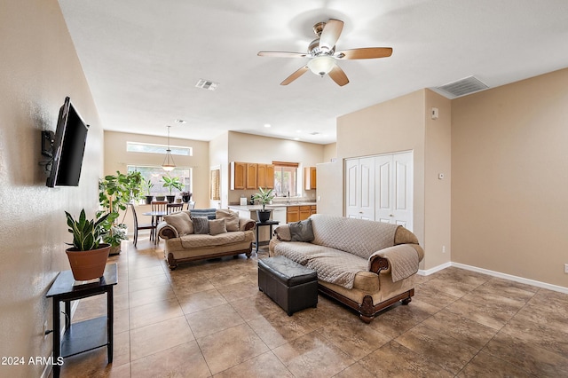 tiled living room featuring ceiling fan