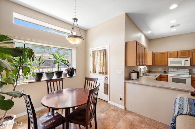 dining room featuring sink and light tile patterned floors