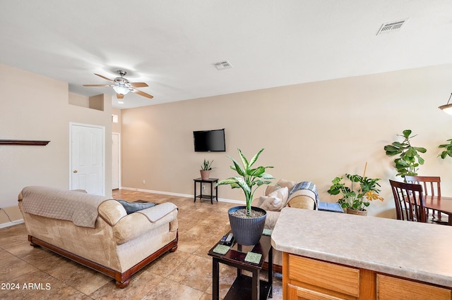 tiled living room with ceiling fan