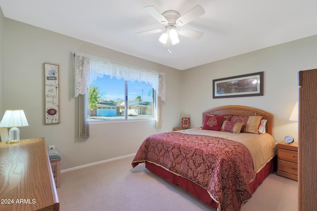 bedroom featuring ceiling fan and light carpet