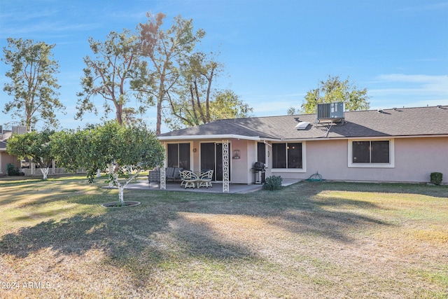 back of house featuring a yard, central air condition unit, and a patio