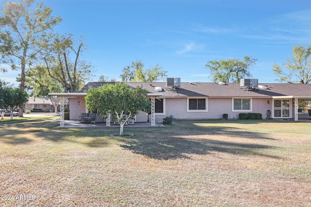 back of property with a patio, cooling unit, and a yard