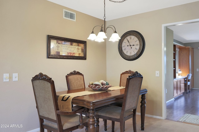 dining room with a chandelier and hardwood / wood-style floors