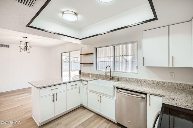 kitchen featuring dishwasher, white cabinetry, sink, and light stone counters