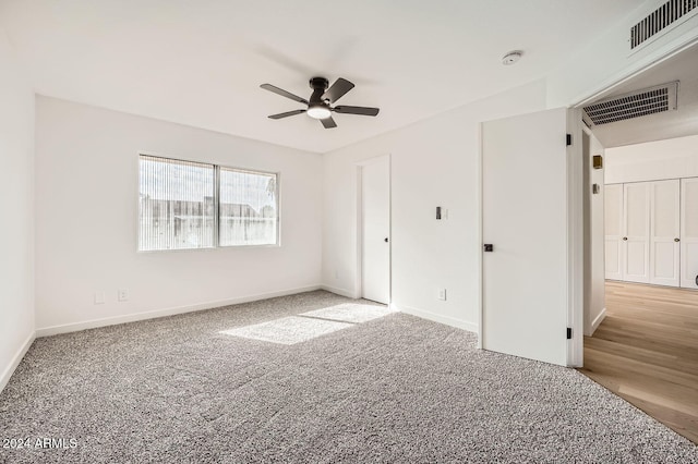 unfurnished bedroom with light colored carpet and ceiling fan