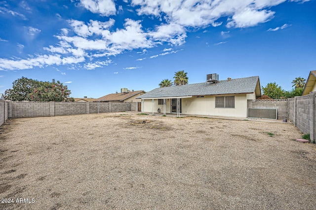 back of property featuring central AC