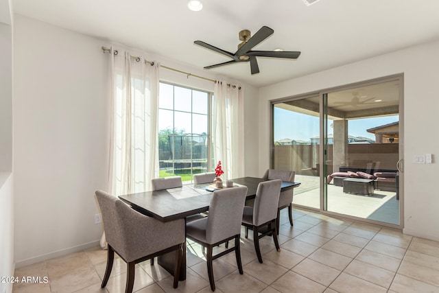 tiled dining space featuring ceiling fan