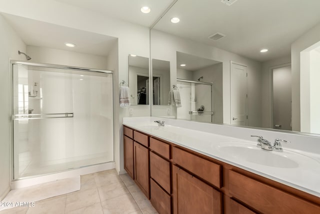 bathroom featuring an enclosed shower, tile patterned floors, and vanity