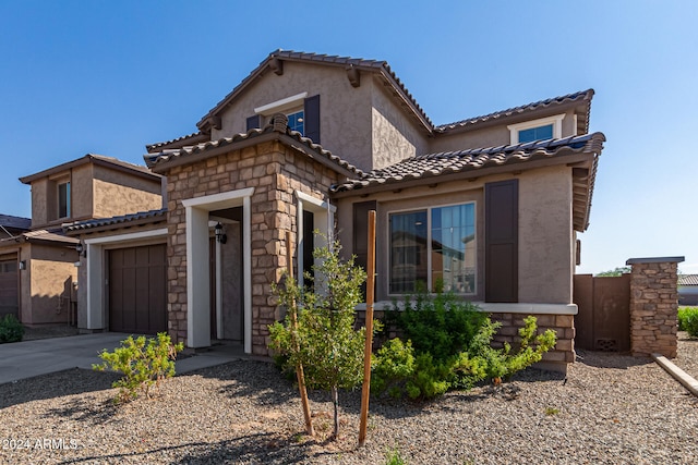 mediterranean / spanish-style home featuring a garage