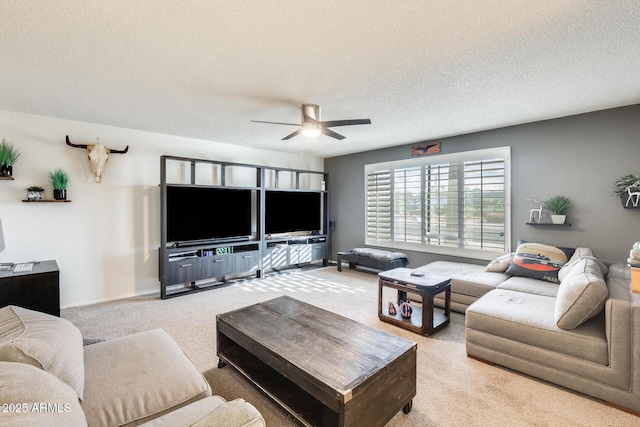 carpeted living room with ceiling fan and a textured ceiling