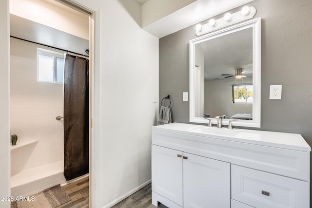 bathroom featuring a shower with curtain, a healthy amount of sunlight, vanity, and hardwood / wood-style flooring