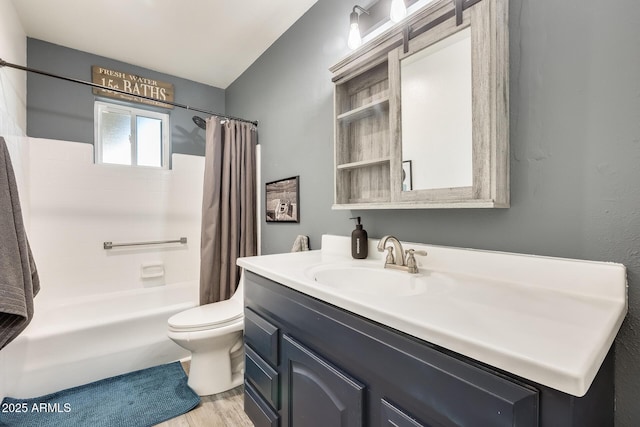 full bathroom featuring shower / tub combo, vanity, hardwood / wood-style floors, and toilet