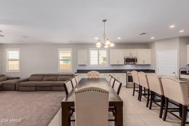 tiled dining area with an inviting chandelier