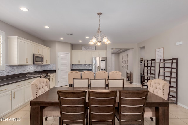 tiled dining space with a notable chandelier