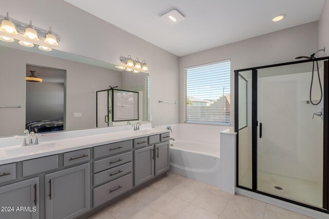 bathroom featuring tile patterned flooring, vanity, toilet, and a bath