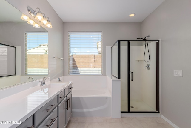 bathroom featuring plus walk in shower, vanity, and a wealth of natural light