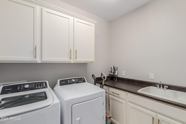 laundry area featuring cabinets, sink, and washing machine and dryer