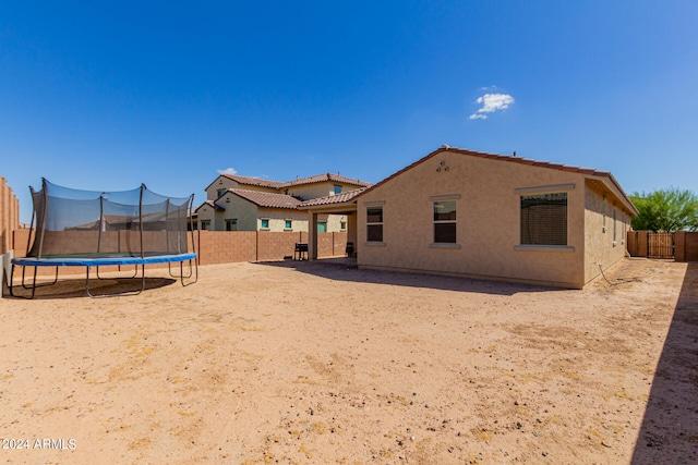 back of property with a trampoline