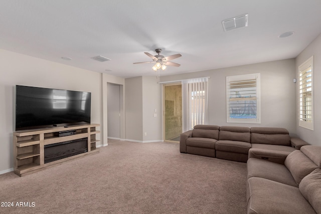 living room with ceiling fan and carpet floors