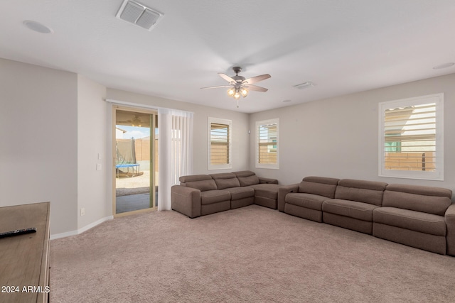 carpeted living room with ceiling fan