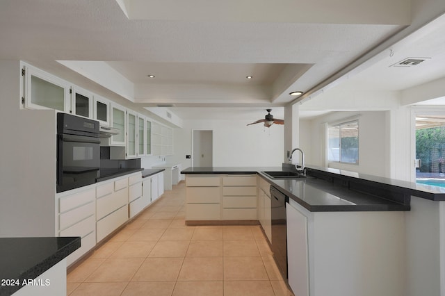 kitchen featuring white cabinetry, sink, black oven, light tile patterned floors, and dishwasher