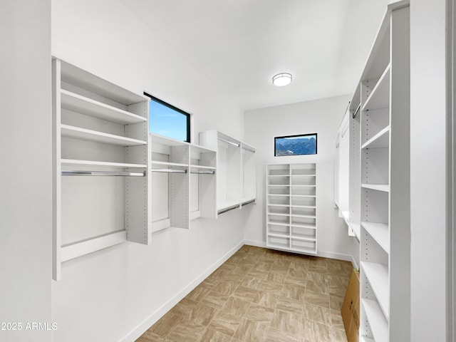 spacious closet with light parquet floors