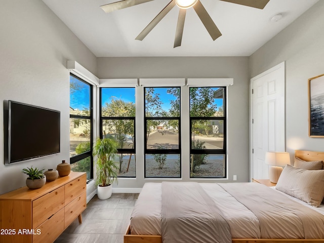 bedroom featuring multiple windows and ceiling fan