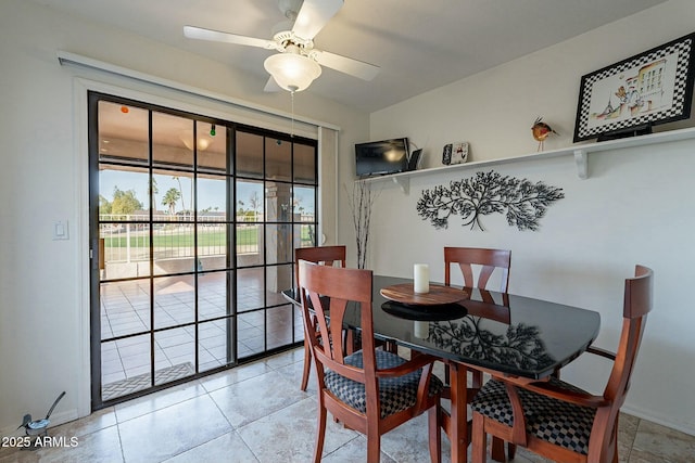 tiled dining room featuring ceiling fan