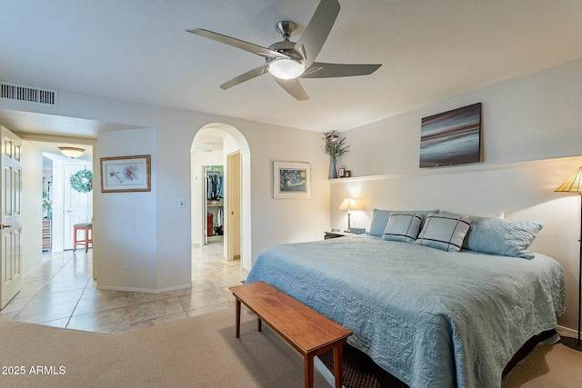 bedroom with ceiling fan and light tile patterned flooring