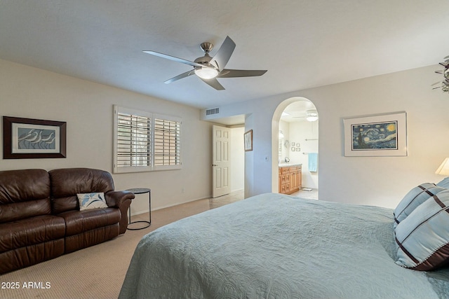 carpeted bedroom featuring ensuite bathroom and ceiling fan