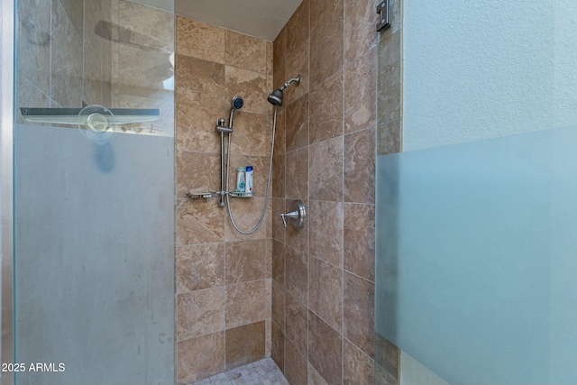 bathroom with tiled shower