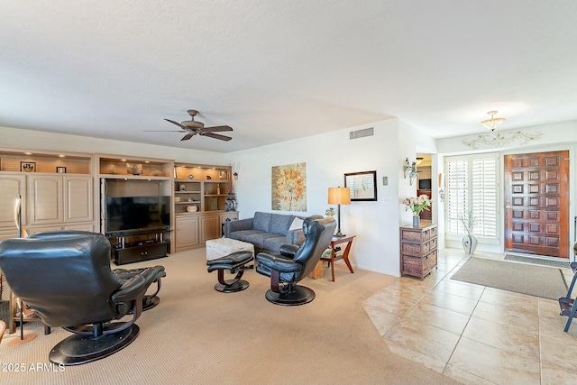 tiled living room featuring ceiling fan