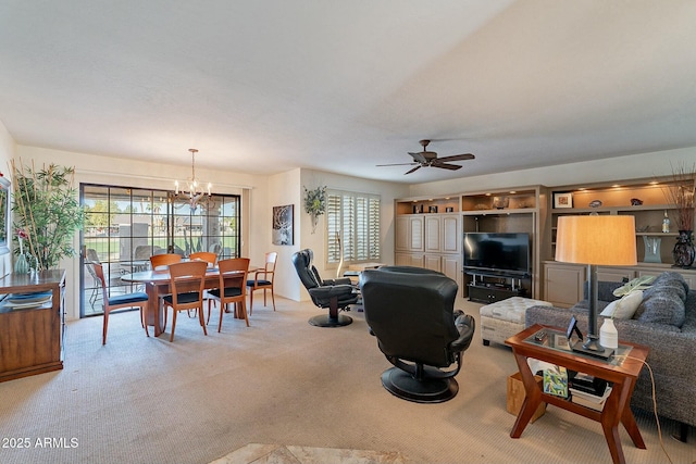 carpeted living room featuring ceiling fan with notable chandelier