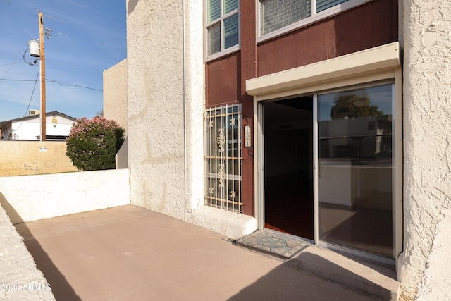 doorway to property with a patio area