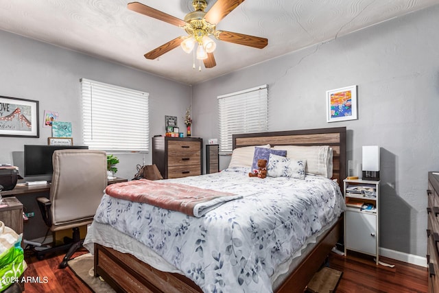 bedroom featuring ceiling fan, baseboards, and wood finished floors