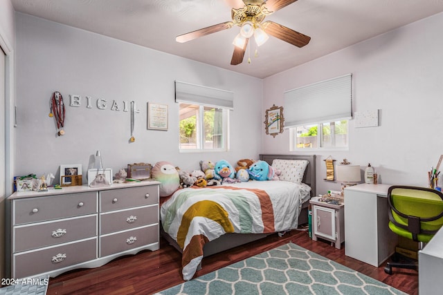 bedroom featuring dark wood-style flooring, multiple windows, and ceiling fan