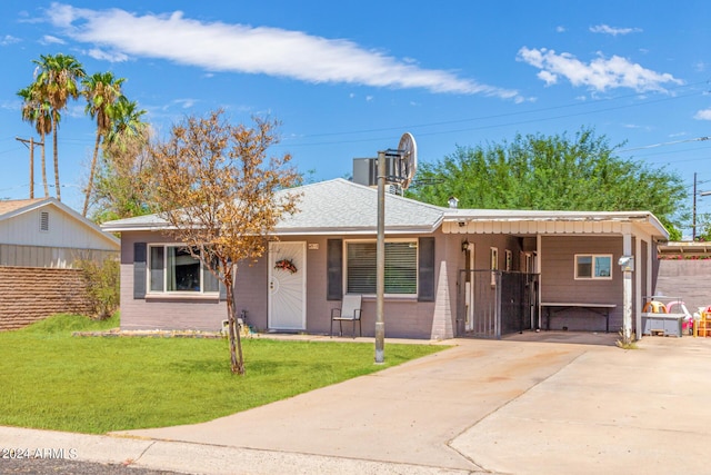 single story home featuring driveway, a shingled roof, fence, and a front yard