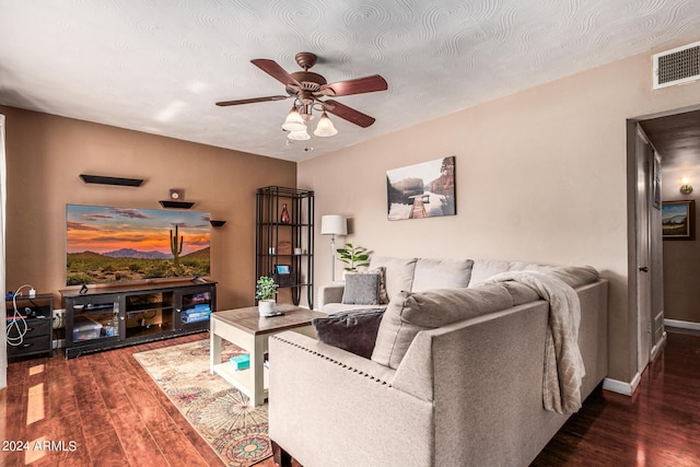 living area featuring ceiling fan, wood finished floors, visible vents, and baseboards