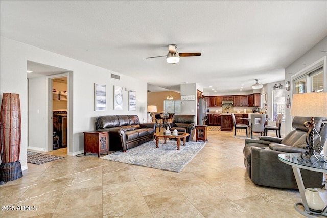 living room featuring visible vents, ceiling fan, baseboards, and light tile patterned flooring