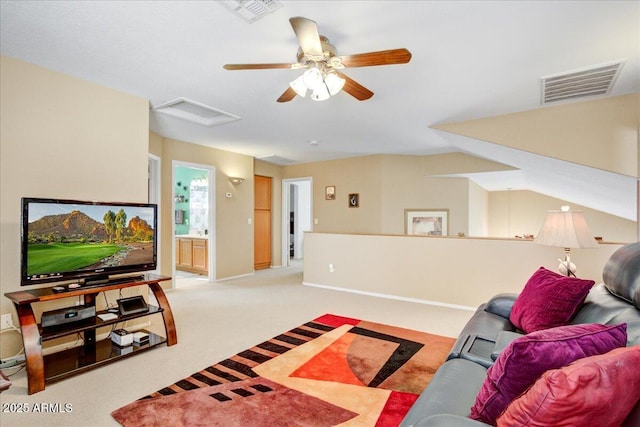 living area with baseboards, attic access, visible vents, and light colored carpet